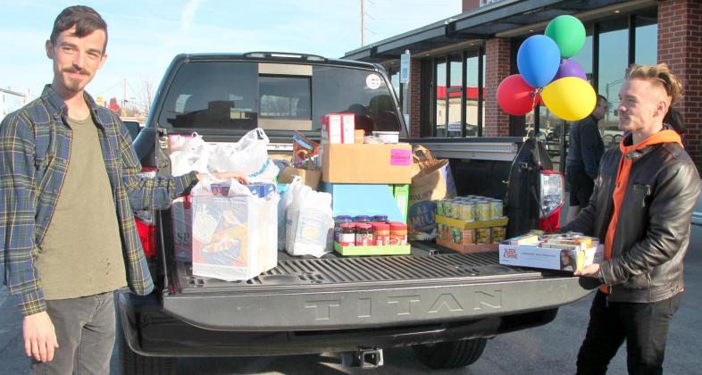 On the left Kyler Selby, Jacob Selby’s brother, and Kody Selby, Jacob Selby’s nephew, load food donations into a truck during the 12th annual food drive, “Jacob’s Moxie Drive,” Feb. 20, at Vacca Territory Creamery &amp; Coffee, 10 W Main. Photo / Carol Mowdy Bond