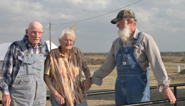 On the left, Raymond Stover and his wife Darlene Stover stand on their Yukon farm spring 2021, with their son Jerry Stover. Photo / Carol Mowdy Bond