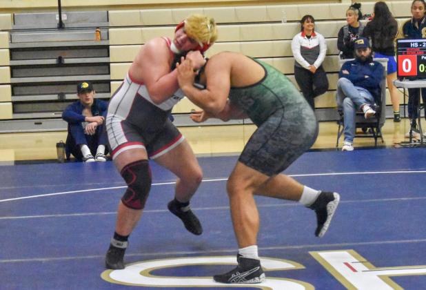 Mustang’s Christian Rowland tangles with Adley Buford in the finals of the 285-pound division at the COAC tourney. Photo / Michael Kinney