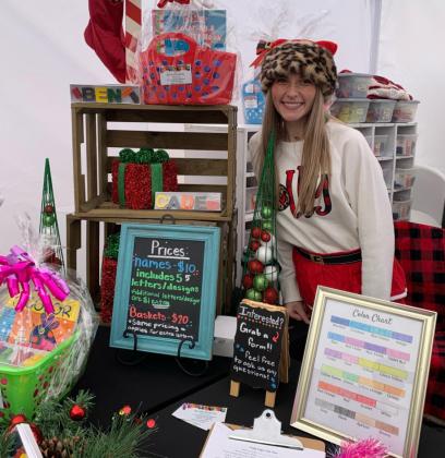 Karly Hietpas, owner of Krafty Krayons, stands in her booth with her crayon creations at the Dec. 4 Yukon 66 Main Street Association’s Yukon Czech Christmas Market at 10 W. Main. Photo / Paula Settle