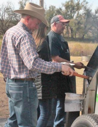 On the left, Canadian County OSU County Extension Director Kyle Worthington flips rib eye steaks for the Nov. 20 Ranch Tour lunch at Growing Paynes/Payne Ranches in Mustang. Photo / Carol Mowdy Bond
