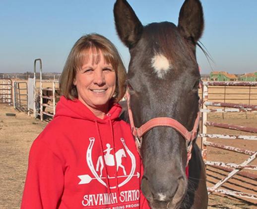 Andi Holland stands with Beauty the horse at Savannah Station Therapeutic Riding Program, located at 13420 Frisco Road in Yukon. Photo / Carol Mowdy Bond