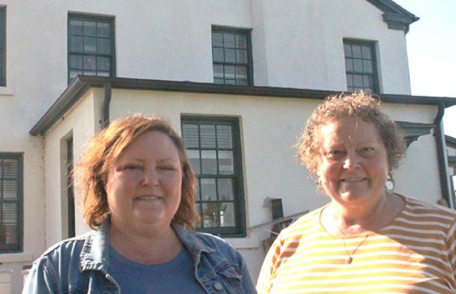 On the left, BlueSTEM Educational Director Ann Marshall stands with Dr. Kristy Ehlers, director of school partnerships and special projects, beside the BlueSTEM AgriLearning Center on the historic Fort Reno grounds, near El Reno. Photo / Carol Mowdy Bond